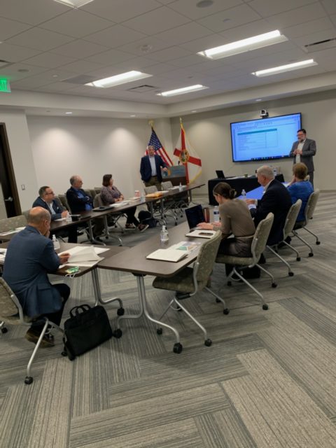 Meeting room with people from Tampa Bay area cybersecurity industry leaders and higher education professionals at USF.